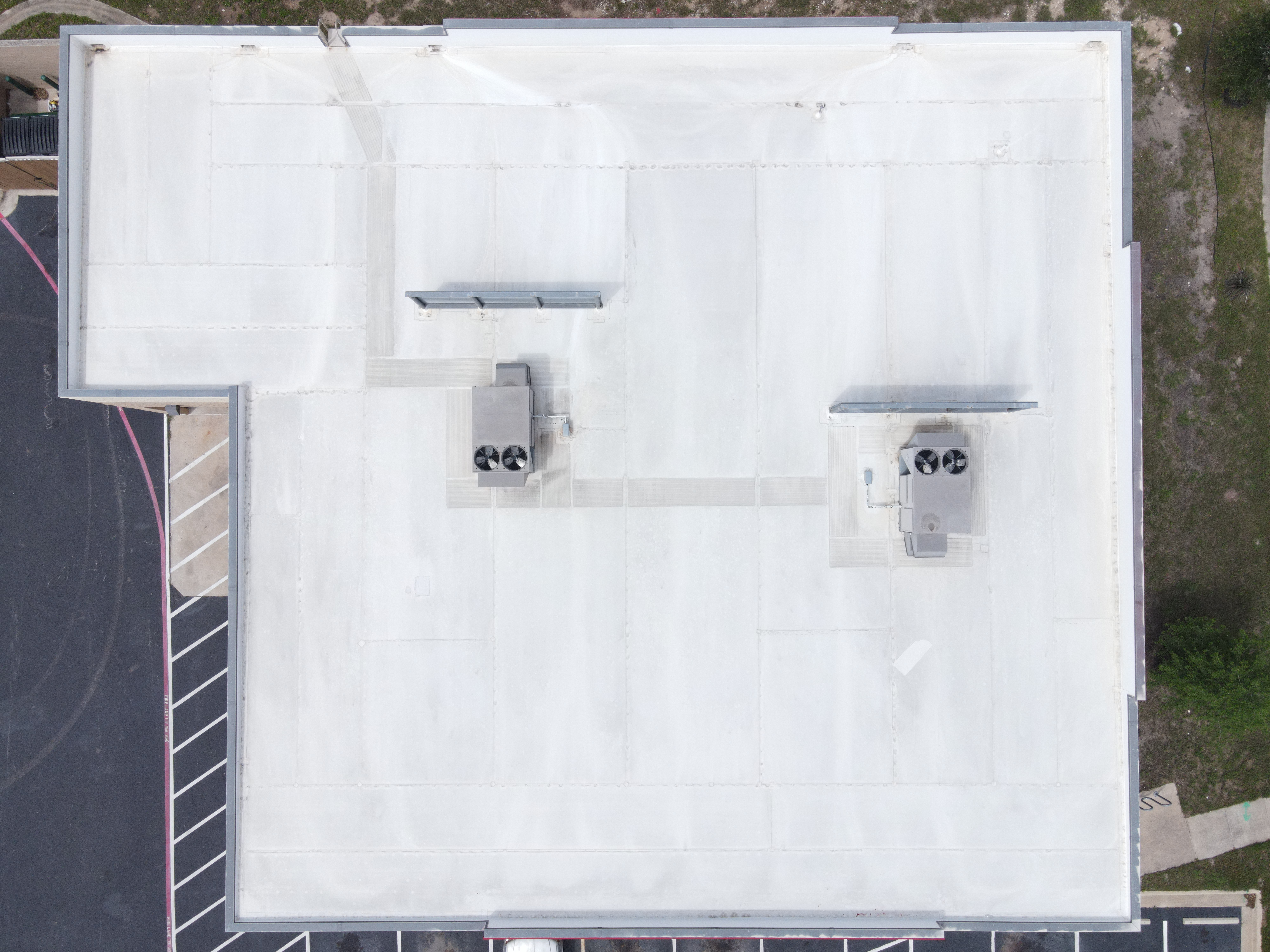Aerial drone roof inspection O'Reilly Auto Parts commercial property Cedar Park Texas — open RTU panel and condensate penetration issues